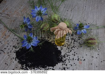 Black Cumin (nigella Sativa Or Kalonji) Seeds In Heart-shaped Bowl On Wooden Background
