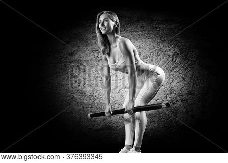 Charming Girl Does An Exercise Called Deadlift. Bodybar. The Concept Of Fitness, Bodybuilding And He