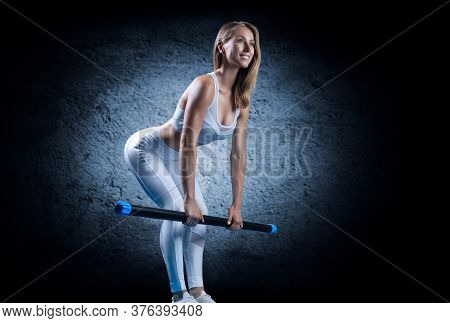 Charming Girl Does An Exercise Called Deadlift. Bodybar. The Concept Of Fitness, Bodybuilding And He