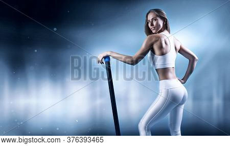 Charming Girl Posing With A Bodybar. The Concept Of Fitness, Bodybuilding And Healthy Lifestyle.