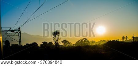 Sun Rays Coming Through The Trees And Electric Towers With Fog Enhancing The Light At Sunrise, Aeria