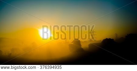 Sun Rays Coming Through The Trees And Electric Towers With Fog Enhancing The Light At Sunrise, Aeria