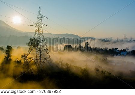 Sun Rays Coming Through The Trees And Electric Towers With Fog Enhancing The Light At Sunrise, Aeria