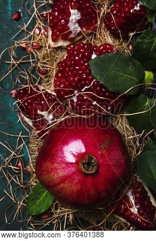 Red Pomegranate In The Starw, Rustic Style, Black Background, Top View