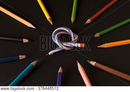 Flexible Pencil And A Set Of Colored Pencils On A Dark Background. Selective Focus