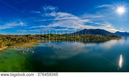 View Over The Beautyful Landscape Of The Bavarian Tegernsee With Boats At A Web And The Alp Mountain