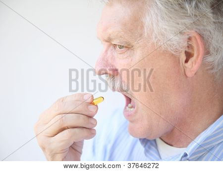 senior takes fish oil supplement