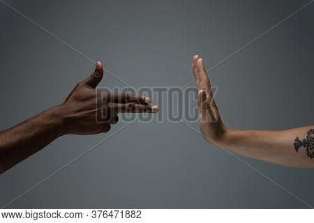 Stop Negative. Racial Tolerance. Respect Social Unity. African And Caucasian Hands Gesturing On Gray
