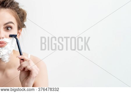 Beautiful Young Caucasian Woman Shaving Her Face By Two Razors On White Background. Pretty Woman Wit