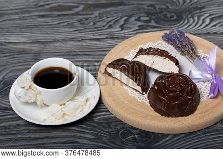 A Cup Of Black Coffee On A Saucer. Nearby Marshmallows In Chocolate. Marshmallows In The Form Of A R