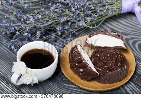 A Cup Of Black Coffee On A Saucer. Nearby Zephyr In Chocolate. Zephyr In The Form Of A Rose. One Zep