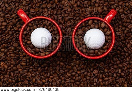 Two Red Cups Full Of Coffee Beans And One Golf Ball.  Fair Trade. Commodity Trade. Fresh Coffee Bean