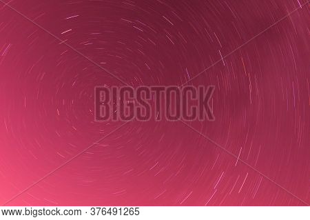 Background Of Round Or Circular Star Track Or Trajectory On The Red, Pink Or Rose Clear Night Sky. S
