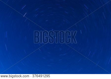 Background Of Round Or Circular Star Track Or Trajectory On The Blue Clear Night Sky. Symbol Of Spac