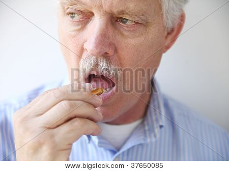 man taking fish oil pill
