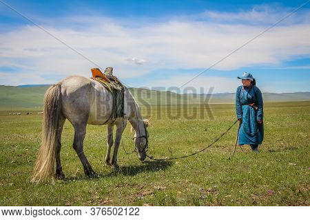 A Happy Female Mongolian Herder And Her Horse, Moron, Mongolia - July 14th 2014