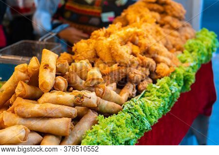 Street Food Market In Asia. Food Counters, Mini Barbecue On A Stick Also Called Satey