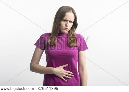 Caucasian Young Woman In Violet T-shirt With Stomachache During Menstruation Putting Her Hands On Ab