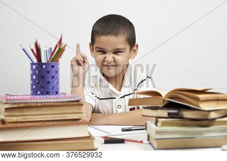 Thoughtful Schoolboy Having Idea, Raising Finger. I Know It. Primary School Pupil Thinking, Creating