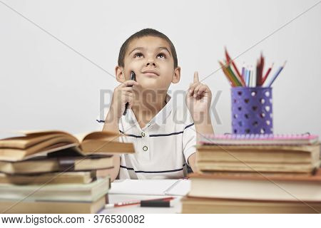 Thoughtful Schoolboy Having Idea, Raising Finger. I Know It. Primary School Pupil Thinking, Creating