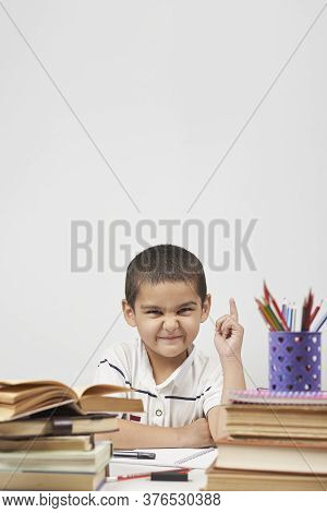 Thoughtful Schoolboy Having Idea, Raising Finger. I Know It. Primary School Pupil Thinking, Creating
