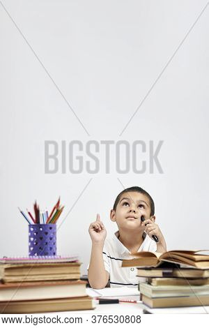 Thoughtful Schoolboy Having Idea, Raising Finger. I Know It. Primary School Pupil Thinking, Creating