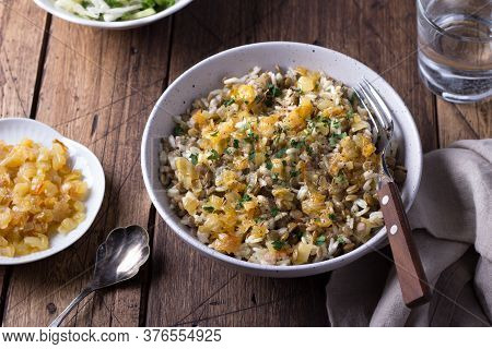 Traditional Middle Eastern Dish, Mujadara Of Lentils, Rice And Fried Onions With A Salad Of Cabbage 