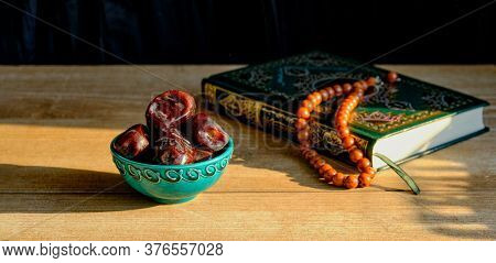 Turquoise Piala With Traditional Oriental Pattern With Dates And Green And Gilded Book Of Quran On T