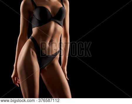 Front Crop Of Incognito Sexy Caucasian Female Model Wearing Black Lingerie Standing, Isolated On Bla