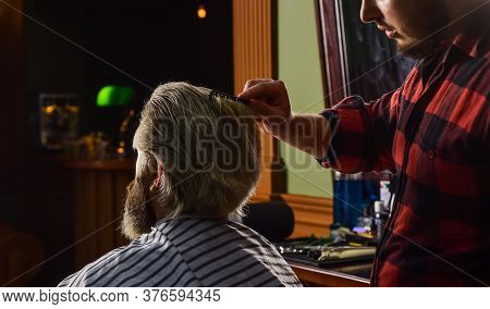 Hipster Client Getting Haircut. Barber With Scissors And Client. Guy With Long Dyed Blond Hair Close
