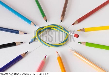 Flexible Pencil And A Set Of Colored Pencils On A Light Background. Selective Focus