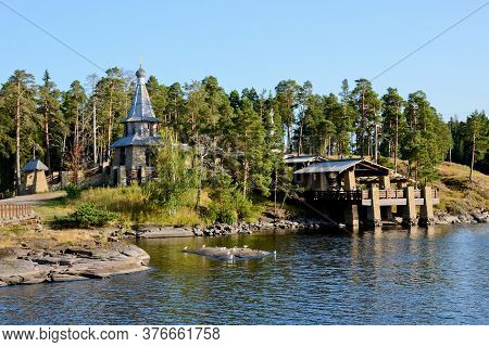 A Wooden Chapel In Honor Of All The Valaam Saints. Beautiful Nature Of The Valaam Archipelago On A C
