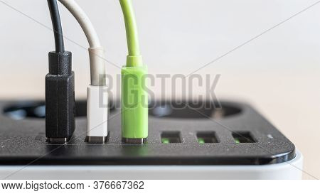 Modern Convenient Multi-port Usb Charger For Devices. Close-up Of Multi-colored Cables In A Power Ou