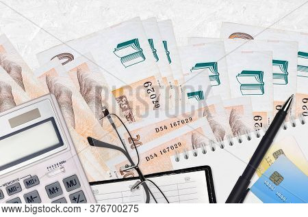 200 Czech Korun Bills And Calculator With Glasses And Pen. Tax Payment Concept Or Investment Solutio