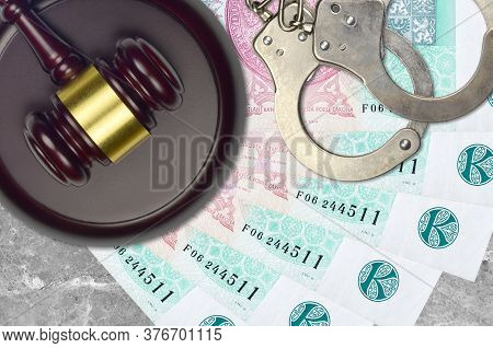 100 Czech Korun Bills And Judge Hammer With Police Handcuffs On Court Desk. Concept Of Judicial Tria