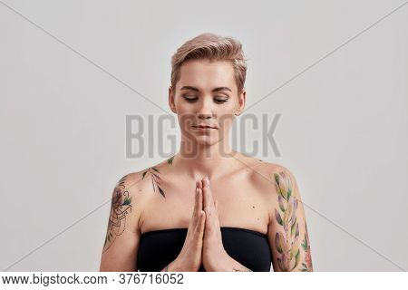 Portrait Of Half Naked Tattooed Woman Keeping Hands Folded In Praying Position And Asking For Help O