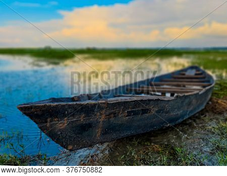 Empty Wooden Boat On The Side Of A River In A South Asian Village During The Rainy Season.asian Wood