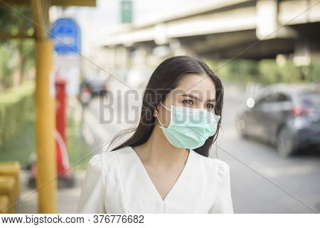 Beautiful Woman Is Wearing Face Mask In Bus Stop