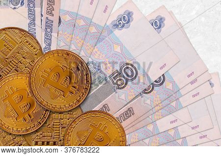 50 Russian Rubles Bills And Golden Bitcoins. Cryptocurrency Investment Concept. Crypto Mining Or Tra