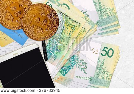 50 Belorussian Rubles Bills And Golden Bitcoins With Smartphone And Credit Cards. Cryptocurrency Inv
