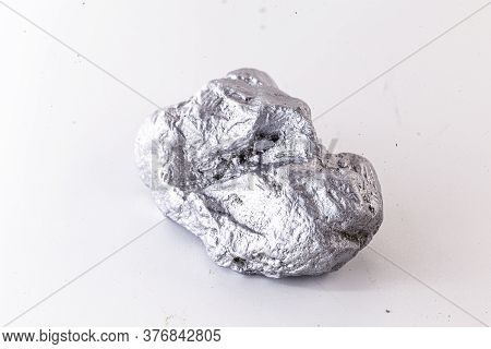 Macro Shot Of Nickel Metal Ore Piece Isolated On A White Background. Closeup Photo Of Surprising Shi
