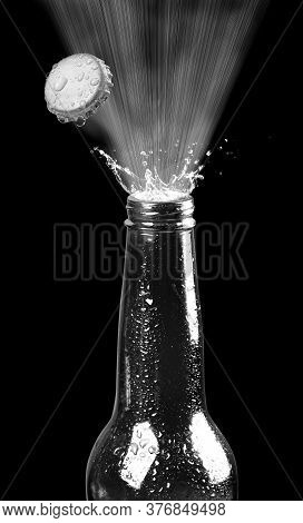 Beer Bottle Popping Its Cap In Black And White.