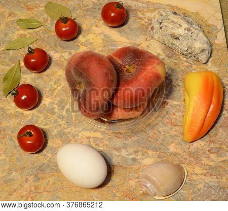 Vegetables, Fruits, Seashells And An Egg On A Marble Surface: Cherry Tomatoes, Bell Peppers, Bay Lea