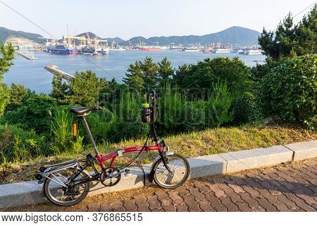Geoje, South Korea - June 14, 2017 : Brompton Folding Bike Parks On The Hill Over Dsme Habour In Geo