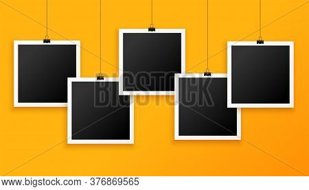 Five Hanging Photo Frames On Yellow Background