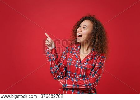 Excited Young African American Girl In Pajamas Homewear Posing While Resting At Home Isolated On Red