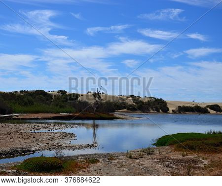Brackish Water Lagoon And Blue Sky With Some Clouds, Maspalomas, Gran Canaria, Canary Islands