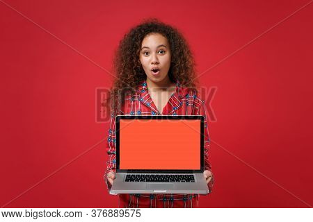 Shocked Young African American Girl In Pajamas Homewear Rest At Home Isolated On Red Background. Rel