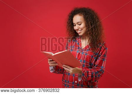 Smiling Young African American Girl In Pajamas Homewear Posing While Resting At Home Isolated On Red