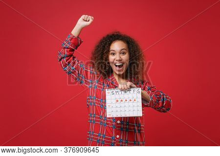 Happy African American Girl In Pajamas Homewear Resting At Home Isolated On Red Background. Relax Go